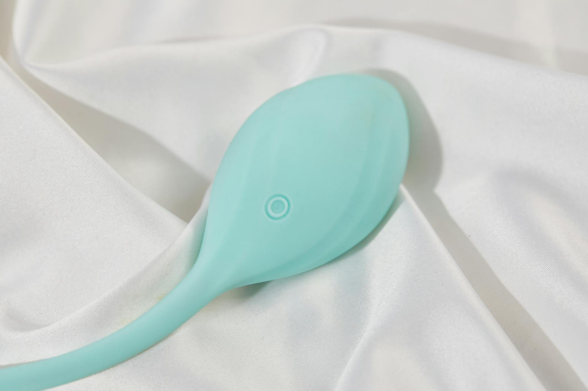 Lemon clitoral vibrator on silk fabric, representing sensation and intimacy