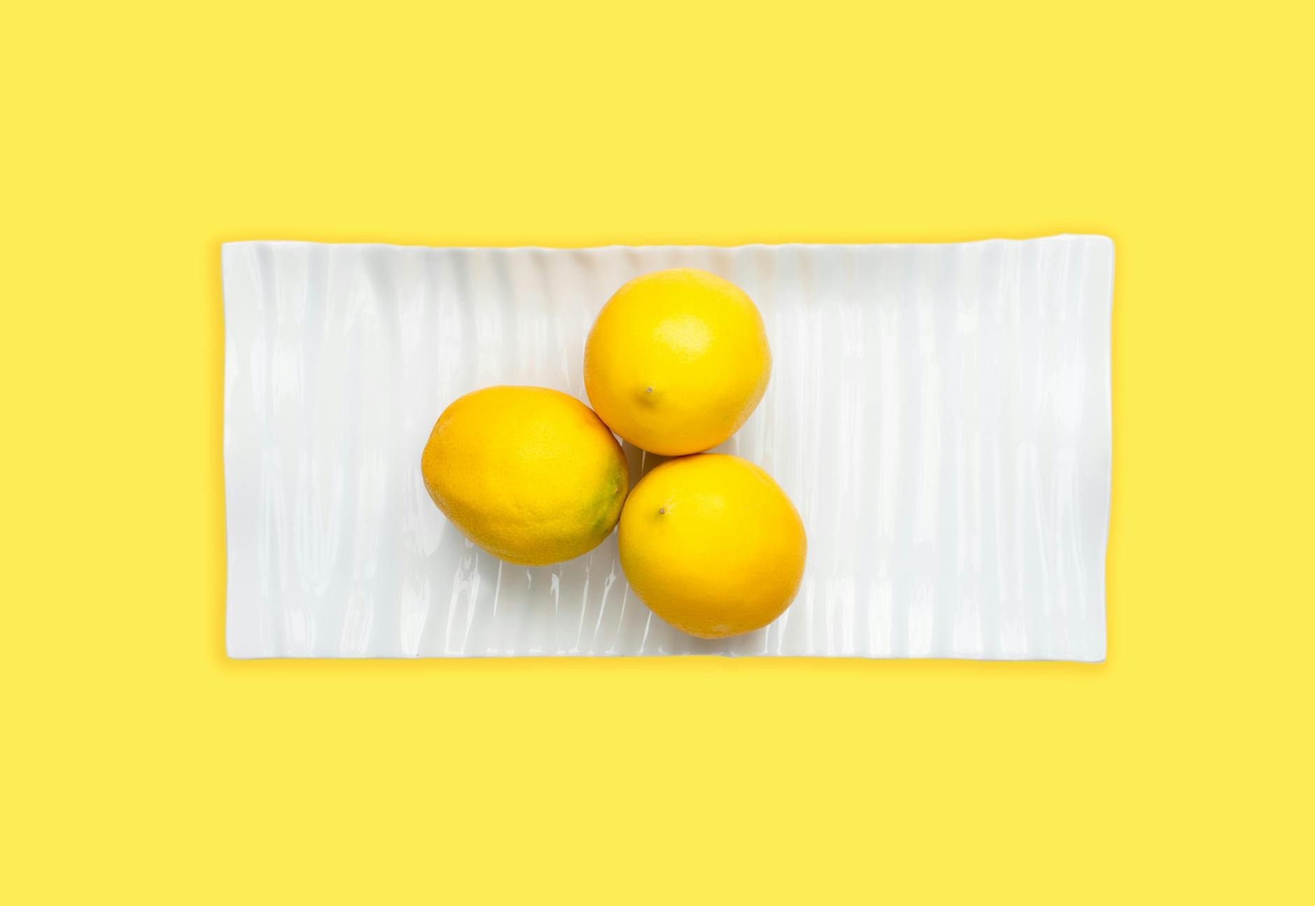Two fresh lemons held in cupped hands, symbolizing touch and presence.