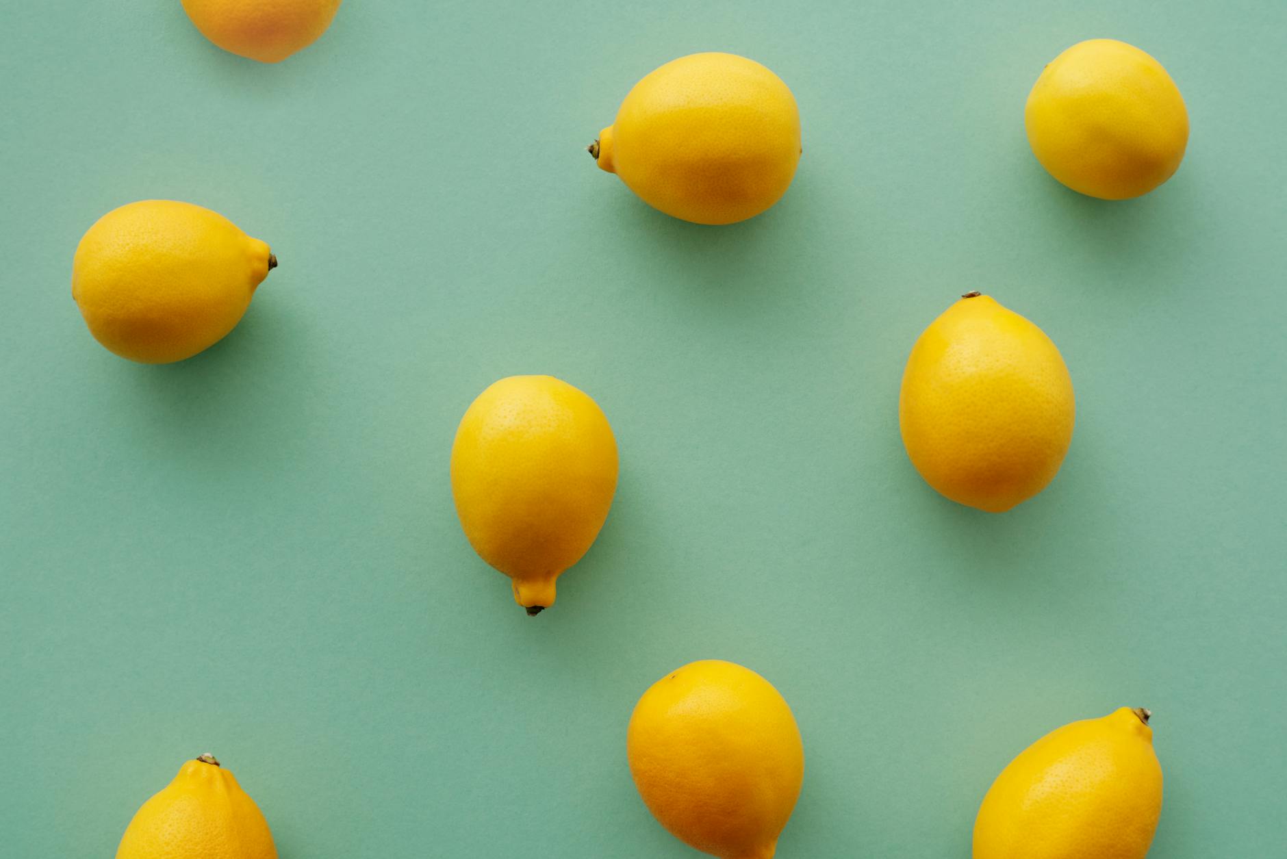 A yellow silicone vibrator surrounded by peeled bananas on a vibrant yellow background