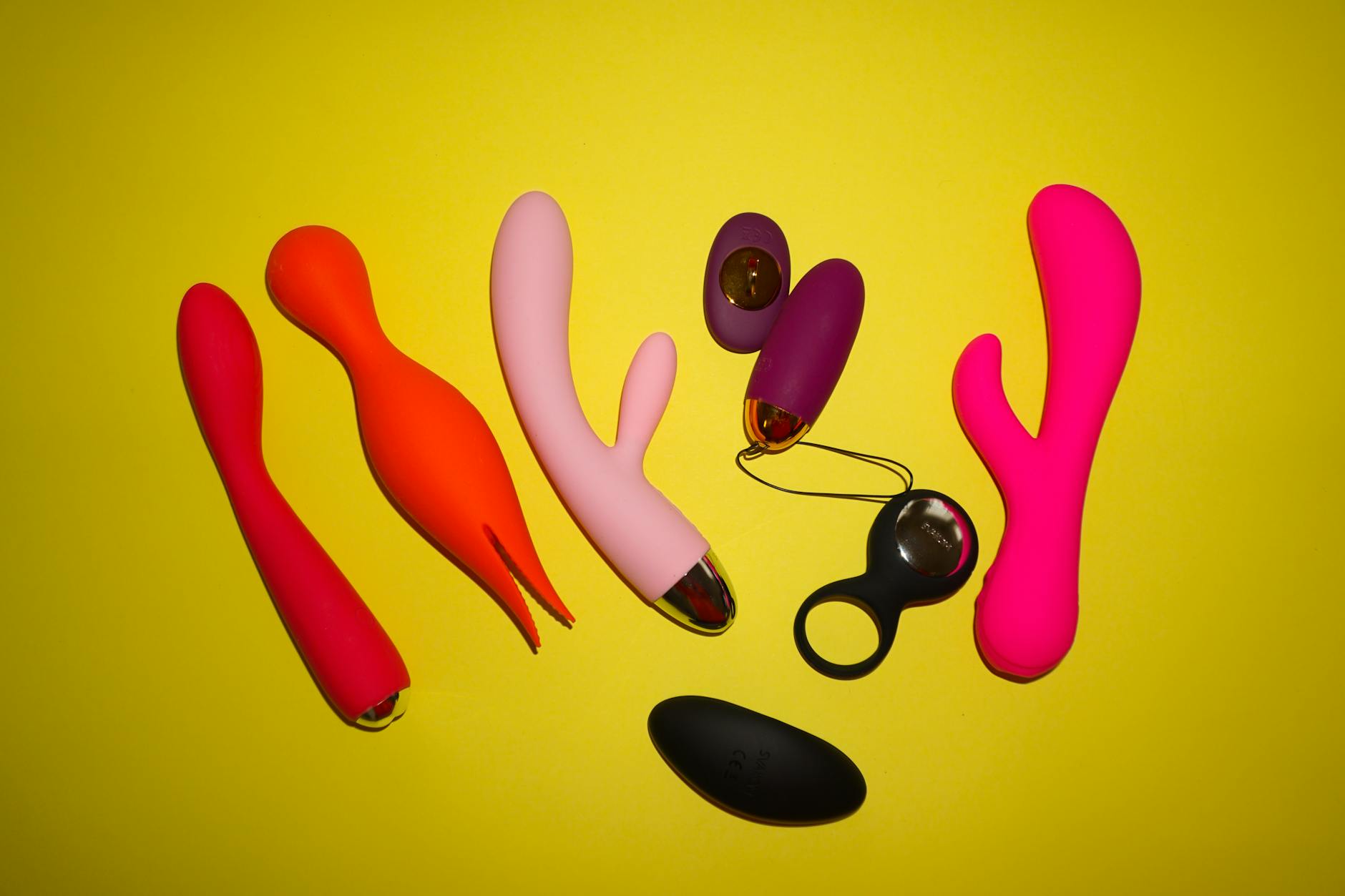 A young couple holding a blue clitoral vibrator together, symbolizing shared intimacy and reconnection